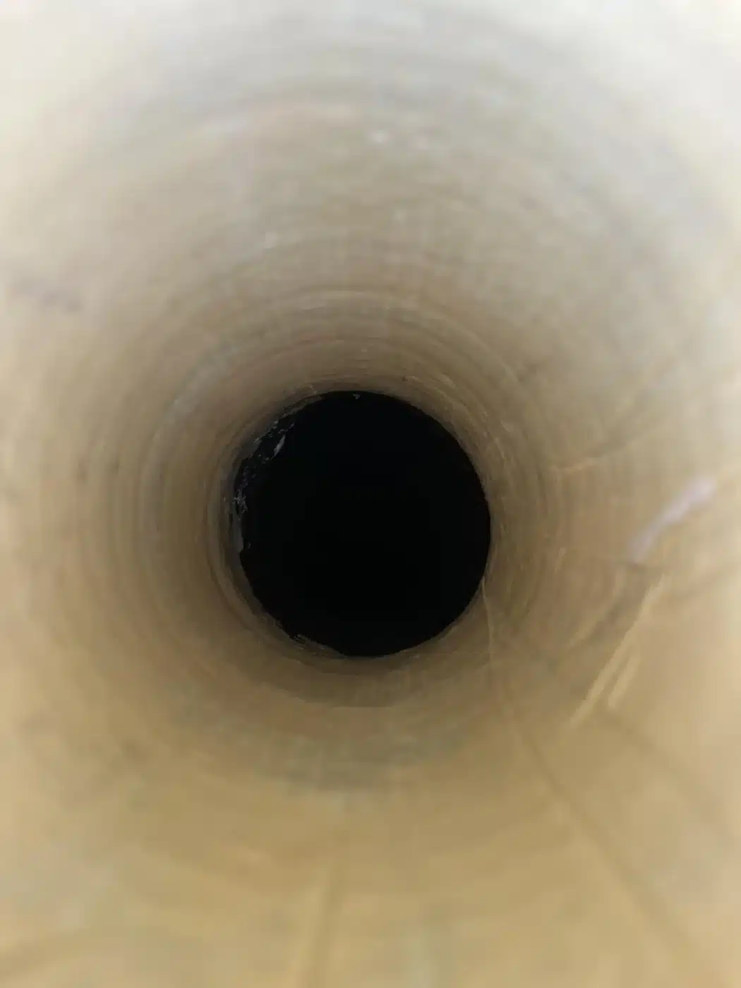 View through a smooth relined drainage pipe after no-dig repair work.